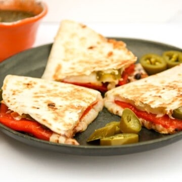 A plate of quesadillas on a table, with Quesadilla and Cheese